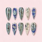 Abalone Noir stiletto press-on nails in black and fuchsia with iridescent shell panels framed in silver