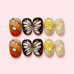 Amber Wing short press-on nails in cocoa and champagne with fanned butterfly wing panels and pearl accents