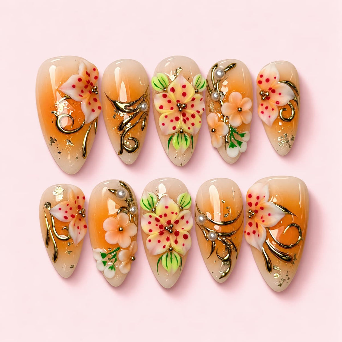 Apricot Lily almond press-on nails in cream and apricot with sculpted speckled lilies, gold vines and pearls