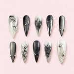 Ashen Heart stiletto press-on nails in black, grey and bone with sculpted hearts, silver stars and beads