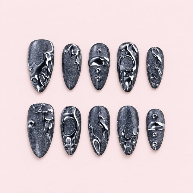 Black Chrome Liquid Metal Almond Press-On Nails with black cat-eye shimmer, raised silver chrome swirls and metal bead accents