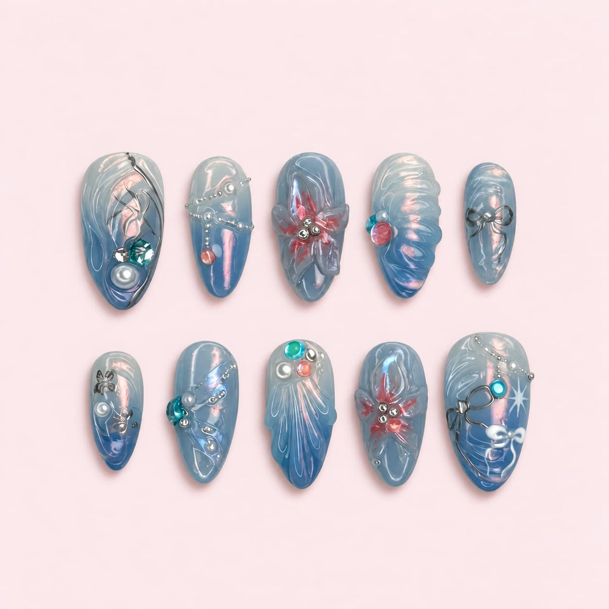 Blue Aura Ocean Almond Press-On Nails with iridescent blue gel, 3D starfish and coral, silver bows, pearls and colorful gems