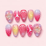 Blush Lily short almond press-on nails in pastel pink and lavender with sculpted lilies, carved shells and colour droplets