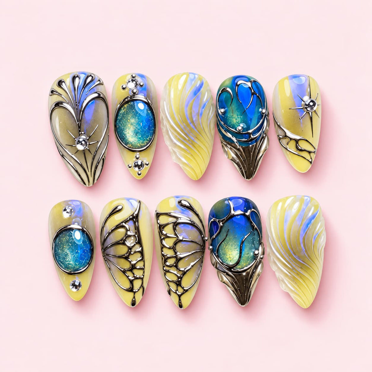 Chrysalis almond press-on nails in pale lemon and pearl with silver butterfly wing outlines and blue-green stones
