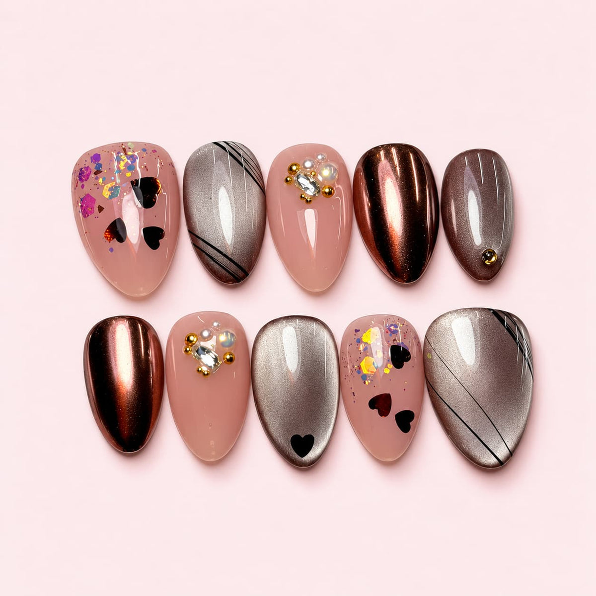 Cocoa Heart short almond press-on nails in nude pink and metallic cocoa with black holographic hearts and a clear stone cluster