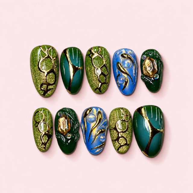 Emerald Vine almond press-on nails in moss and forest green with gold-toned vine work and champagne cut stones