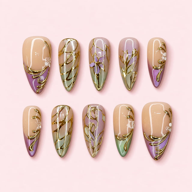 Gilded Iris almond press-on nails in nude lavender and sage with raised gold irises, leaves and scrolling vines