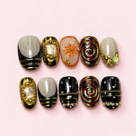 Gilded Noir short press-on nails in black, sage and deep gold with beaded frames, pearls and a painted lily