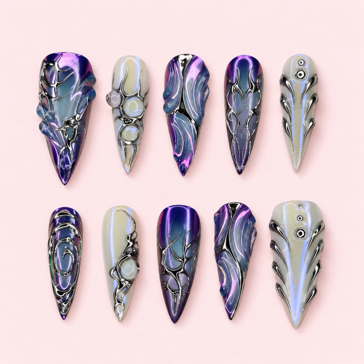 Iris Armour stiletto press-on nails in violet and pearl white with silver tribal line work and sculpted ridges