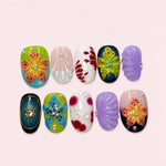 Island Mix short press-on nails with sculpted lilies, lavender and pink shells and a gold sun on black