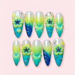 Lagoon Bloom almond press-on nails in milk, lime and turquoise with sculpted lime flowers and carved shell detail