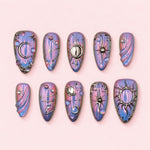 Nebula Rite almond press-on nails in pink and violet aurora with silver moons, suns, stars and a sculpted planet