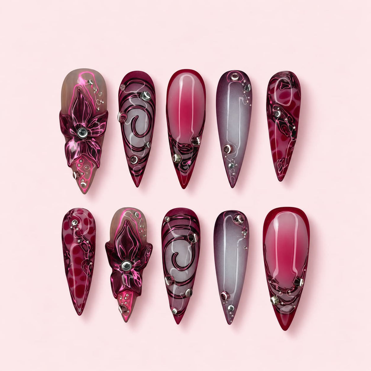 Neon Orchid stiletto press-on nails in burgundy and smoke with sculpted orchids outlined in neon pink
