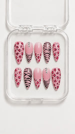 Pink animal print almond press-on nails with hand-painted leopard and zebra patterns, gradient pink accents, gemstones, and glossy gel finish