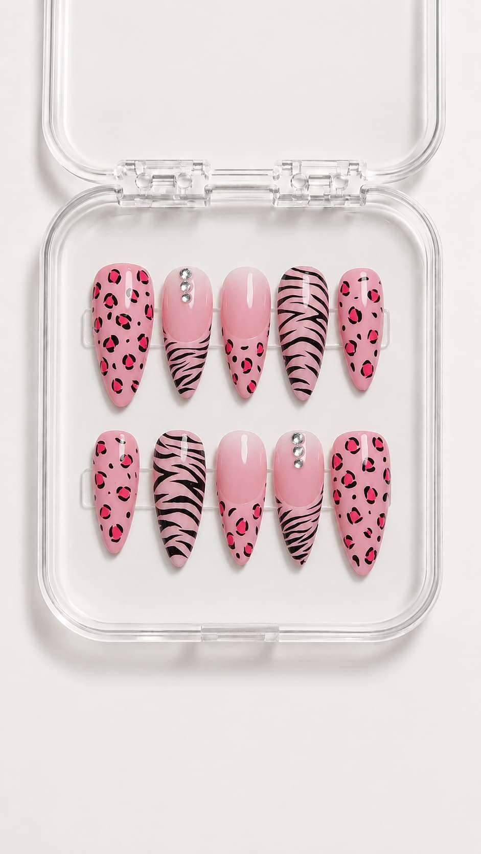 Pink animal print almond press-on nails with hand-painted leopard and zebra patterns, gradient pink accents, gemstones, and glossy gel finish