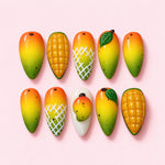 Ripe Mango almond press-on nails in orange, yellow and green with carved scored flesh, 3D leaves and a sculpted half fruit