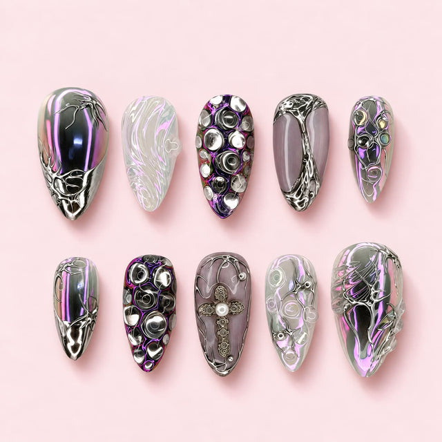 Silver Rite almond press-on nails in pearl grey and violet with silver cell work, domed studs and a filigree cross