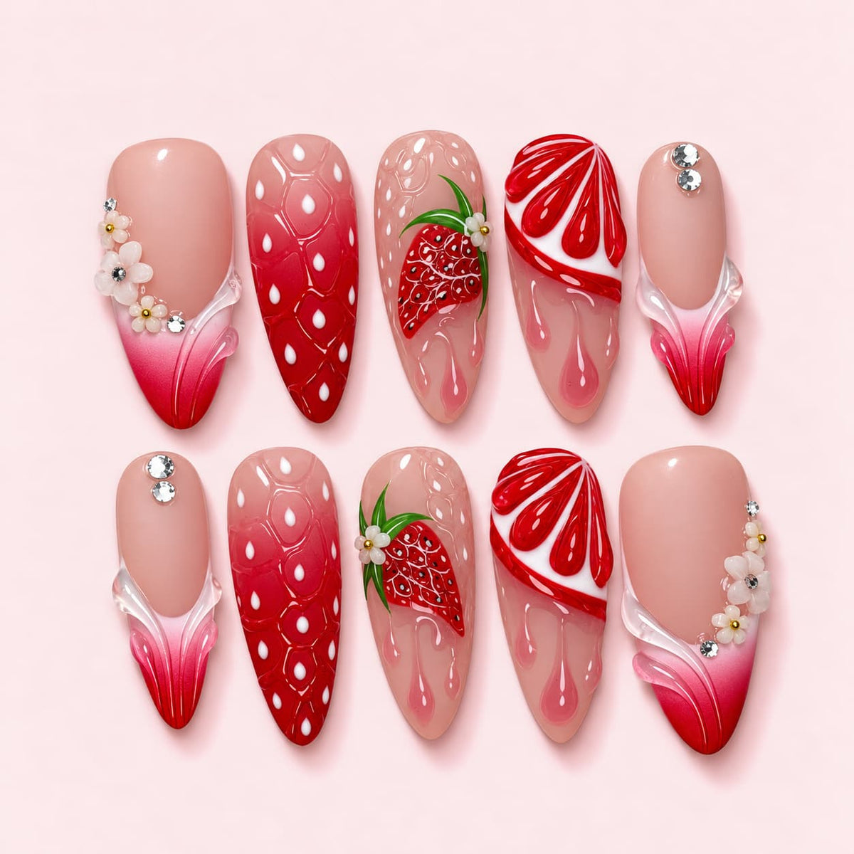 Strawberry Drip almond press-on nails with a carved strawberry, dripping gel pearls and pink ombre wave tips