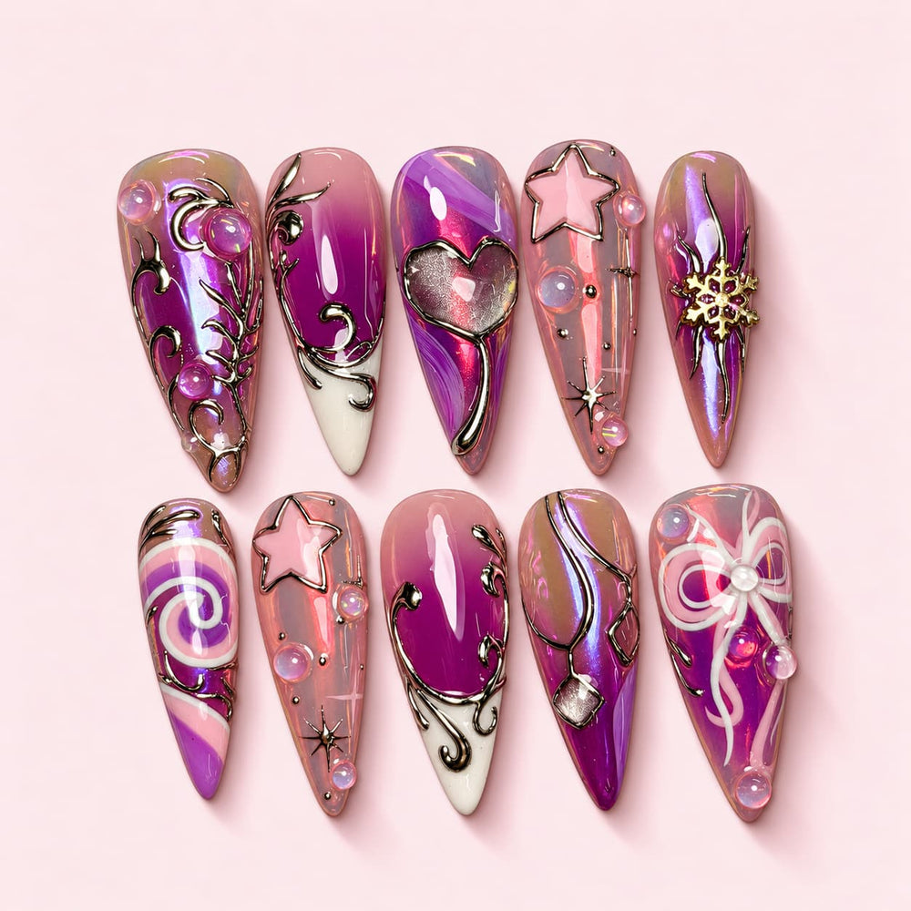 Sugarplum stiletto press-on nails in pink and magenta aurora with silver scrollwork, a 3D heart and a white bow