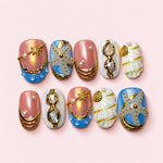 Tide Pool short press-on nails in pearl pink and sea blue with gold shell charms, sculpted starfish and pearls