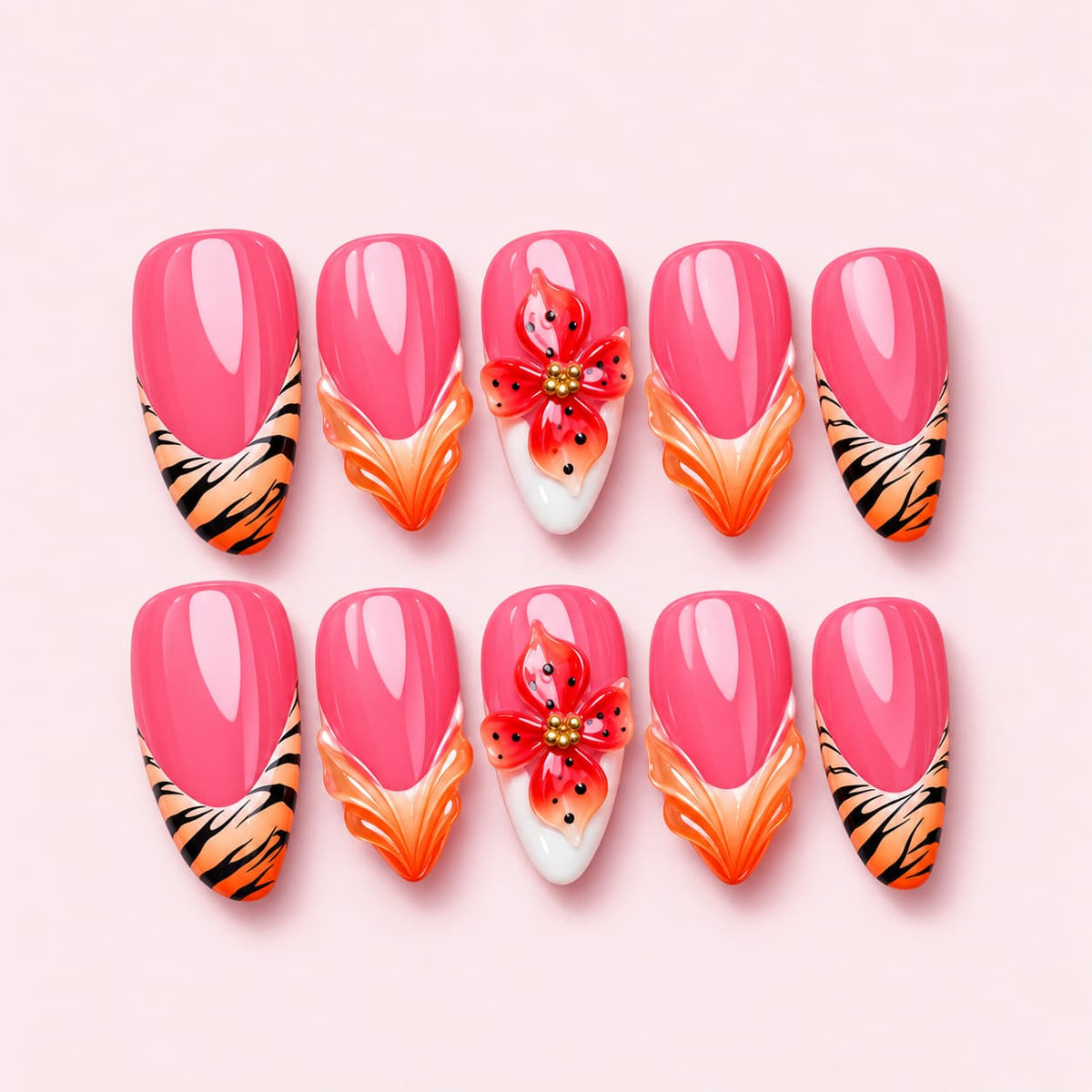 Tiger Lily almond press-on nails in watermelon pink with tiger stripe tips and a sculpted red speckled lily