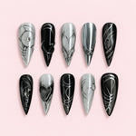 Black Silver Chrome stiletto press-on nails with glossy black base, silver chrome line art, heart motif and rhinestone accents