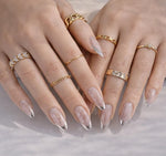 Nude glitter short nails with silver chrome French tips and gold rings