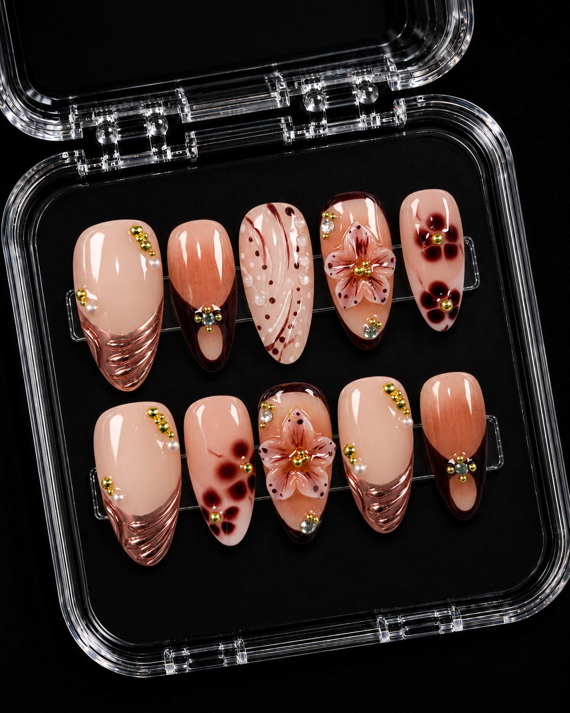 Brown floral French tip short nails with nude base, 3D flowers, pearls, and gold accents displayed as a press-on nail set.