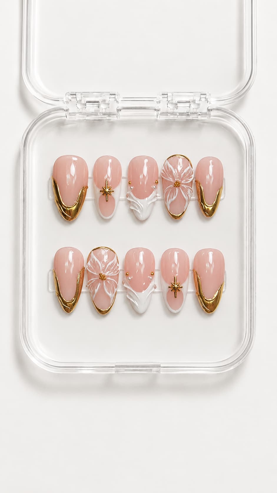 Gold French tip almond press-on nails with 3D white flower, star charms, pearl and gemstone accents