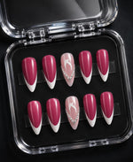 Hot pink almond press-on nail set with white French tips and rhinestone accent design