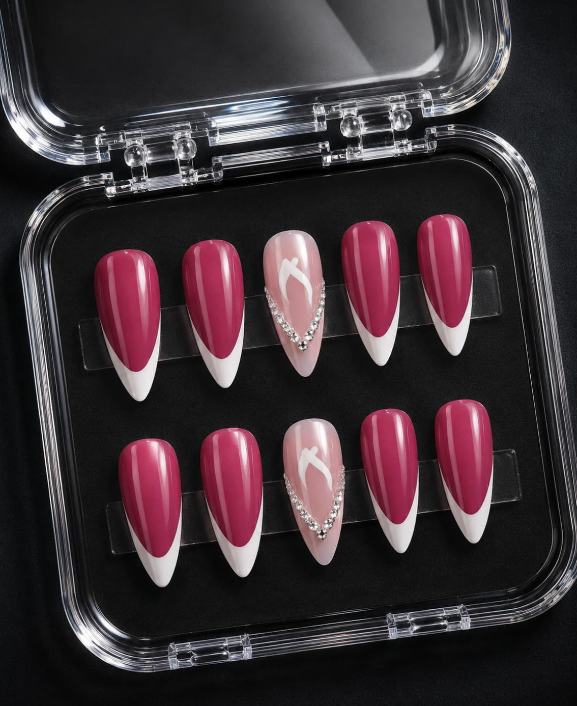 Hot pink almond press-on nail set with white French tips and rhinestone accent design