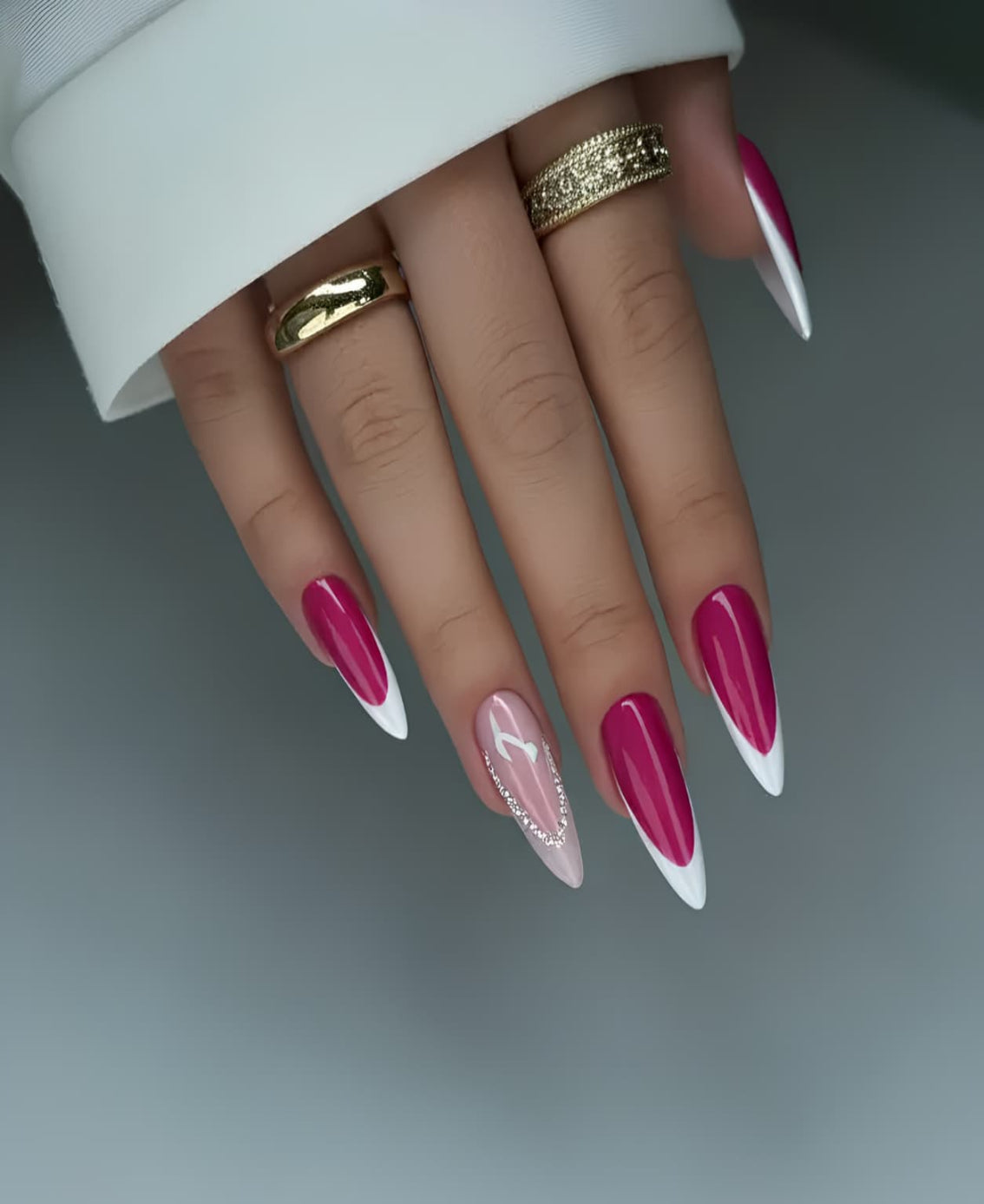 Hot pink press-on nails with white French tips and pink rhinestone accent on almond-shaped nails