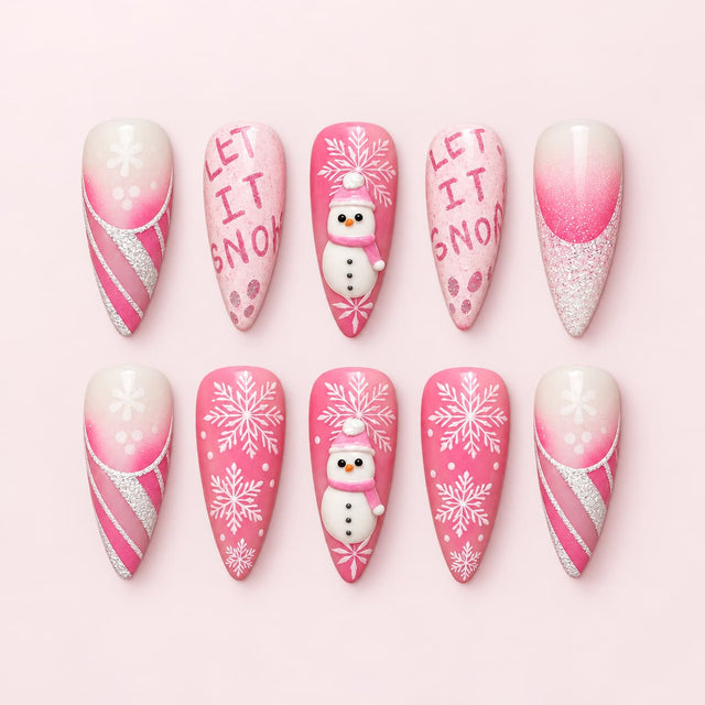 Let It Snow Pink Stiletto Press-On Nails with 3D snowmen, white snowflakes, pink glitter French tips, candy cane stripes and hand-lettered holiday designs.