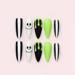 Lime Slime Skeleton Stiletto Press-On Nails with black and white stripes, skeleton faces, neon green drips, and lime accent nails.