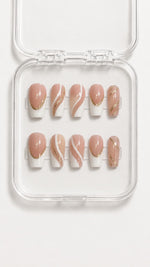 MUOI pink French tip press-on nails worn on almond-shaped nails in a soft everyday setting