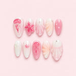 Pink 3D Jellyfish Seashell Almond Press-On Nails with a milky translucent base, sculpted jellyfish, seashell details, flower accents, and pearl beads.