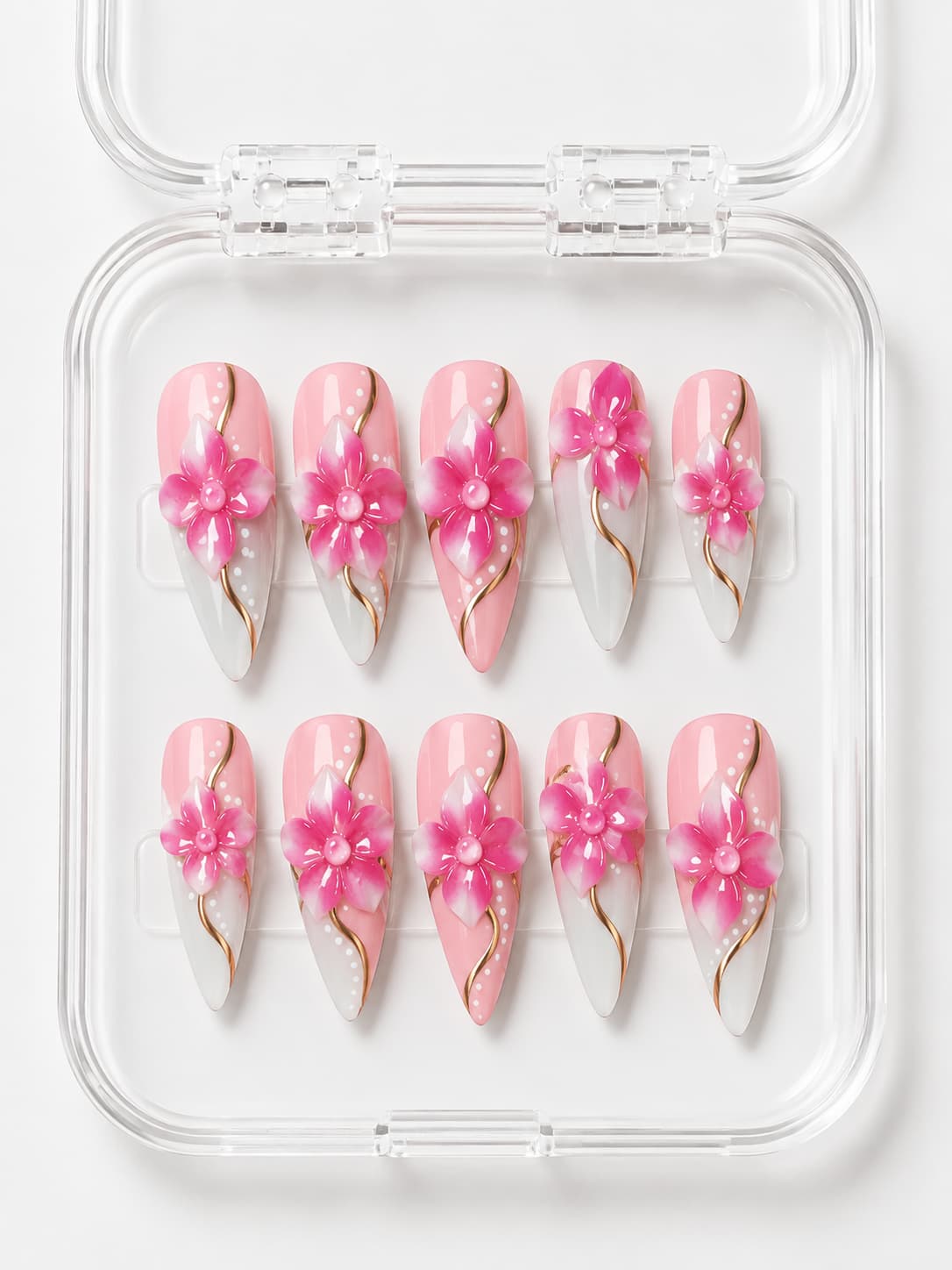 Pink and white stiletto press-on nails with 3D pink flowers, gold curved lines, and hand-painted white dot accents.