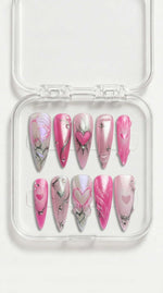 Pink pearl stiletto press-on nails with hand-painted hearts, silver swirl details and gemstone accents