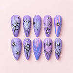 Purple Silver Chrome Stiletto Press-On Nails with lilac iridescent bases, raised silver swirls, rhinestones, and heart details