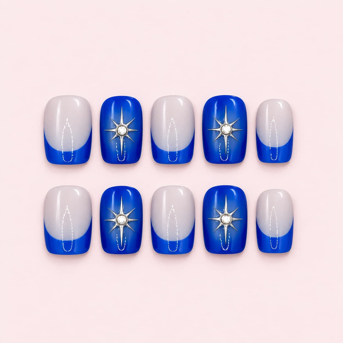 Royal blue French tip short square press-on nails with a nude sheer base, silver line detailing, star and gemstone accents