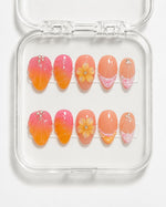 Sunset Seashell Almond Press-On Nails with pink-orange gradient, 3D seashells, yellow flower and gemstone accents