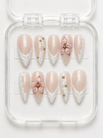 White Floral French Tip Almond Press-On Nails with nude base, 3D white French tips, red floral detail and gold bead accents